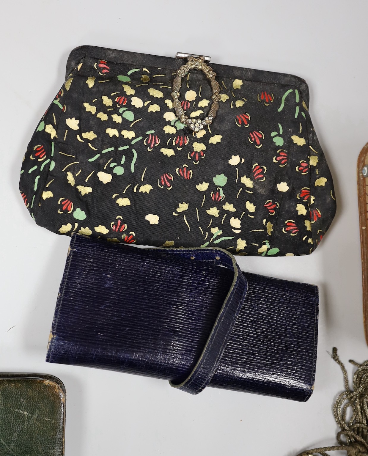 A suitcase containing a collection of late 19th century leather sewing bags and containers, wooden darning mushrooms, etc